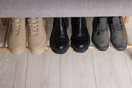 Stand with different stylish shoes indoors, above view. Space for textの写真素材