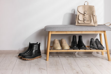 Stand with different stylish shoes and bag indoorsの写真素材