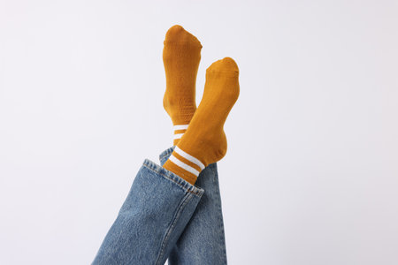 Woman wearing orange socks on white background, closeupの写真素材