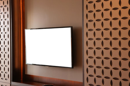 Tv set mounted on wall in roomの写真素材