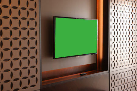 Tv set mounted on wall in roomの写真素材