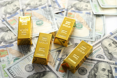 Shiny gold bars and dollar banknotes on table, above viewの写真素材