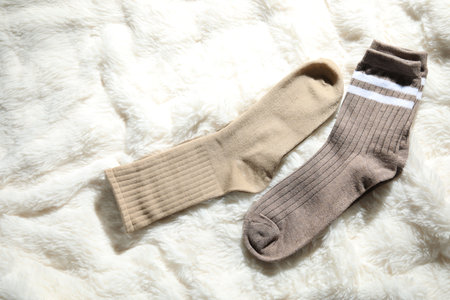 Soft socks on white faux fur, top viewの写真素材