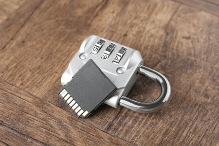 SD memory card and combination padlock on wooden table, closeupの写真素材
