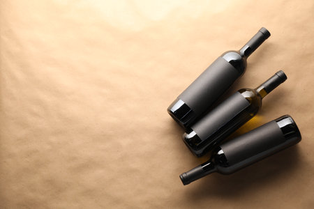 Bottles of wine on parchment paper, flat lay. Space for textの写真素材