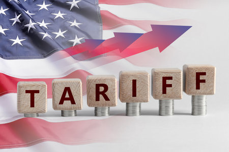 Tariff increase. Stacks of coins with cubes on tableの写真素材