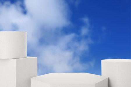 White podiums against blue sky with cloudsの写真素材