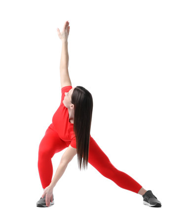 Woman in sportswear exercising on white backgroundの写真素材