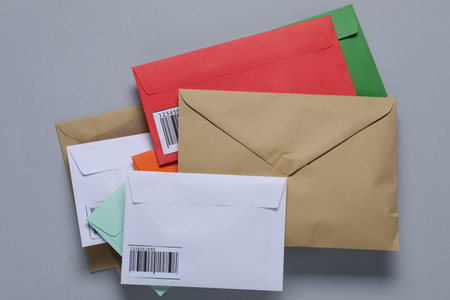 Different paper envelopes on light grey background, top view. Post officeの写真素材