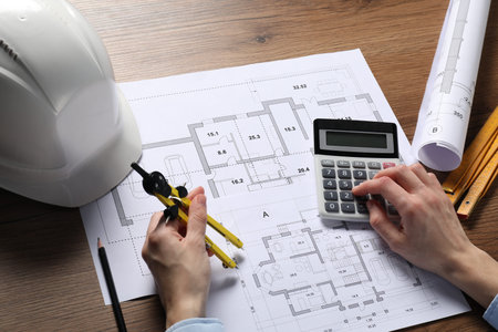 Architect working with project, closeup. Different technical drawings and construction tools on...