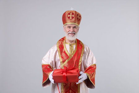 Saint Nicholas with gift on light grey backgroundの写真素材