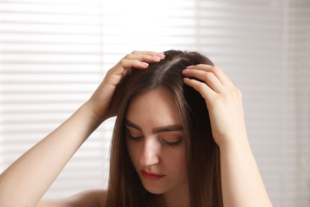Beautiful woman with healthy hair roots at homeの写真素材