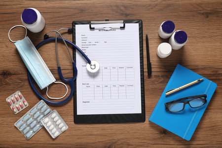 Flat lay composition with medical card form on wooden backgroundの写真素材
