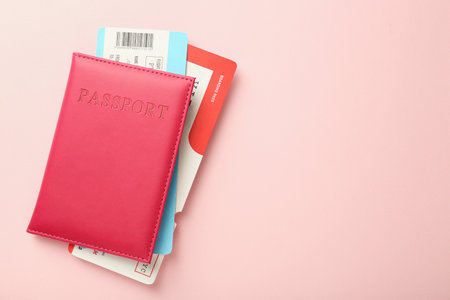 Passport with tickets on pink background, top view. Space for textの写真素材