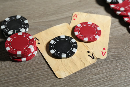 Old vintage playing cards and poker chips on wooden table, closeupの写真素材
