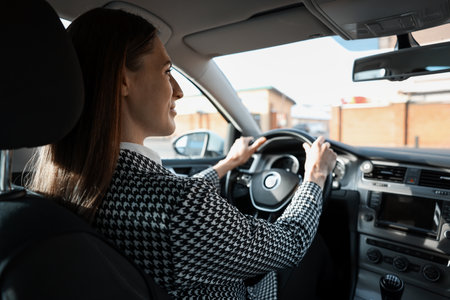 Driver behind steering wheel of modern car, view from insideの写真素材
