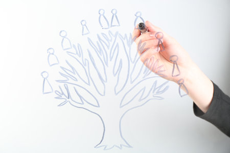 Woman drawing family tree on screen against light background, closeupの写真素材