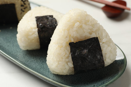 Rice balls (onigiri) on light table, closeup. Traditional Japanese dishの写真素材