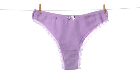 Beautiful panties on clothes line against white background