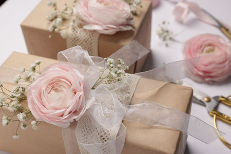 Florist. Boxes, flowers, ribbon and scissors on white background, closeupの写真素材
