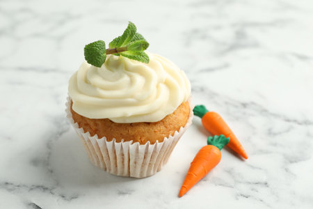 Delicious carrot cupcake with mint on white marble table, closeupの写真素材