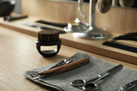 Many different barber's tools on light wooden table in barbershop, closeupの写真素材