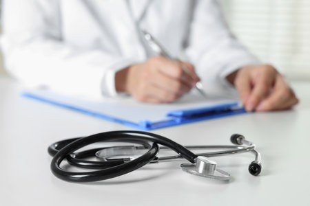 Doctor working and stethoscope on table in hospital, selective focusの写真素材