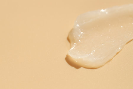 Moisturizing lip balm on beige background, closeup. Space for textの写真素材