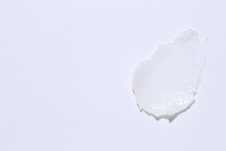 Moisturizing lip balm on white background, top view. Space for textの写真素材