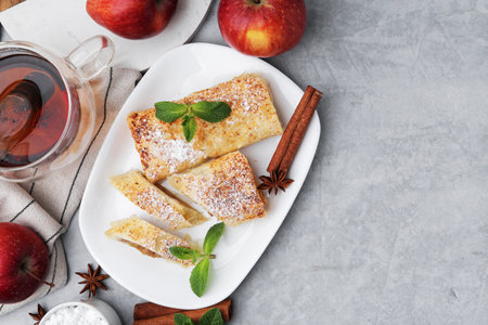 Tasty apple strudels served on light grey table, flat lay. Space for textの写真素材