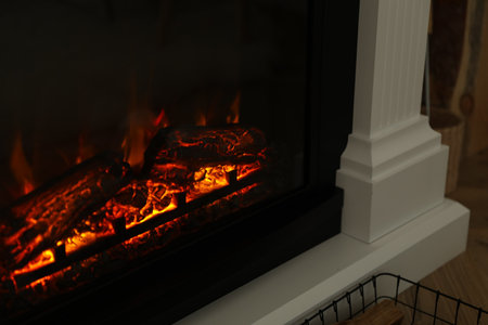 Firewood burning bright in elegant fireplace indoors, closeupの写真素材