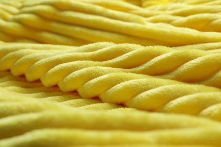 Bright yellow soft woolen fabric, closeup view