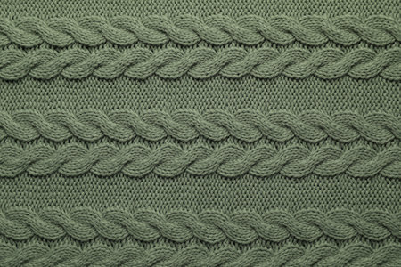 Knitted dark woolen fabric as background, top view
