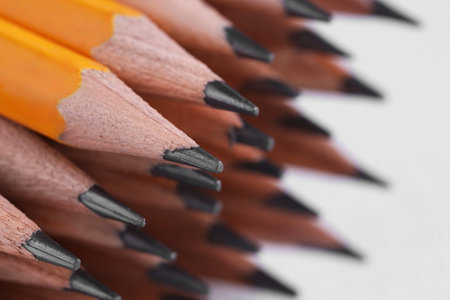 Many pencils on light grey background, closeup