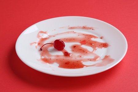 One dirty plate on red background, closeupの写真素材