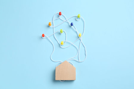 Family tree made with pins and threads on light blue background, top viewの写真素材