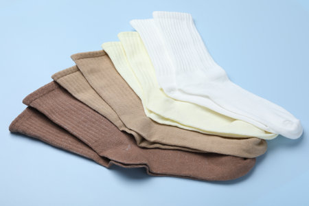Many different pairs of socks on light blue background, closeupの写真素材