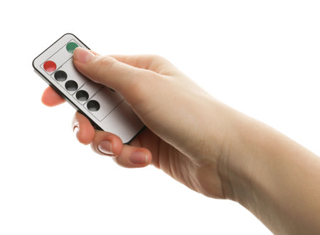 Woman with modern lighting remote control on white background, closeupの写真素材