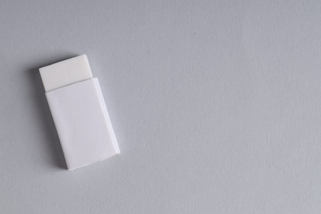 One eraser on grey background, top view. Space for text