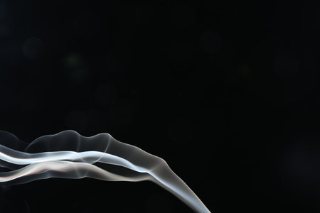 Beautiful smoke in lights on dark background, space for textの写真素材
