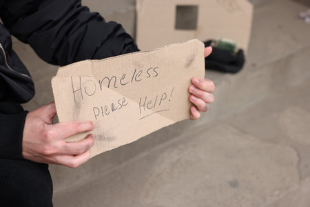 Man with sign Homeless please help outdoors, closeupの写真素材