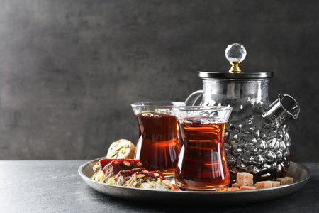 Tasty Turkish tea and delight on black table. Space for textの写真素材