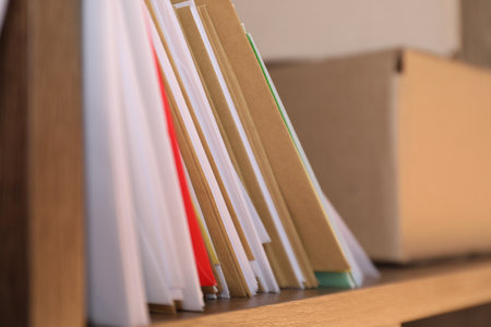 Different papers envelopes and parcel on shelf in post office, closeupの写真素材