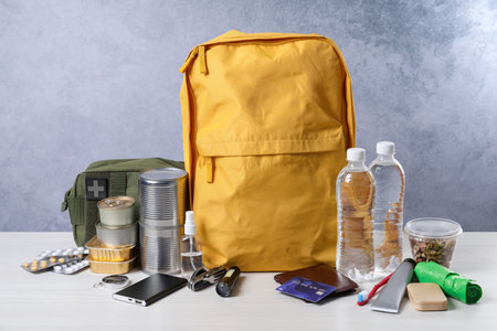 Survival kit. Different emergency supplies on white wooden table