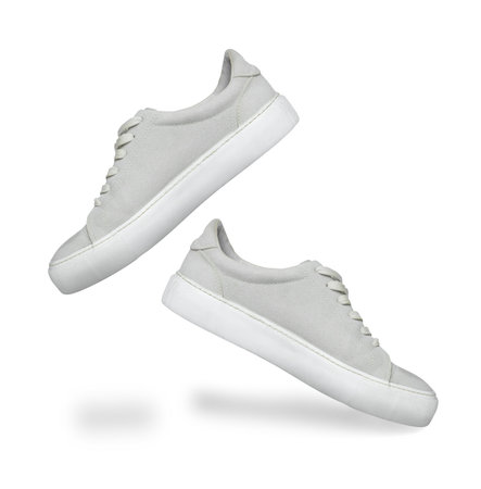 Stylish sneakers in air on white backgroundの写真素材