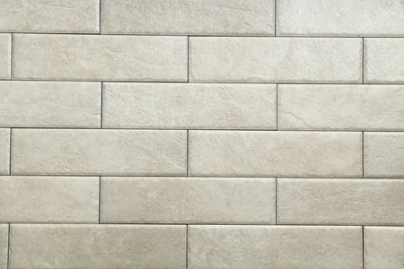Texture of beige tiles as background, closeup