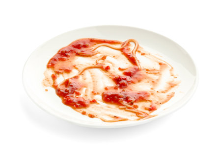Dirty plate with smeared sauce isolated on whiteの写真素材
