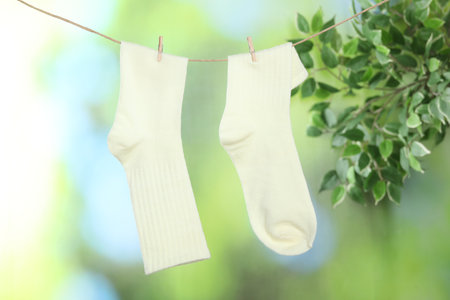 Pair of socks hanging on washing line outdoorsの写真素材