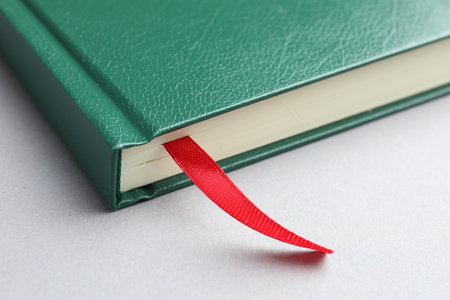 Book with red ribbon bookmark on light grey table, closeupの写真素材