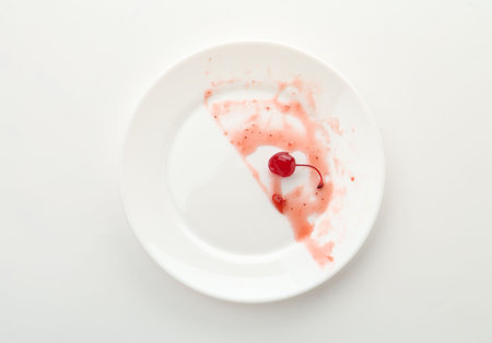 Dirty plate on white background, top viewの写真素材